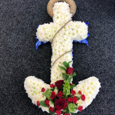 Anchor - This beautiful piece of work is made from white chrysanthemums and created to the customers specifications with added red roses in a corsage to finish the piece off 